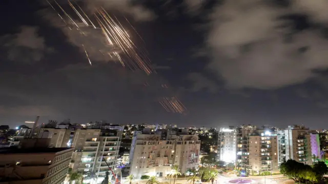 Trails of light in sky above Ashkelon, Israel, as air defences operate against Iranian missiles, 1 October 2024